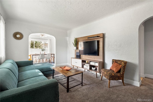 60 Vrain St, Denver, CO 80219 - living room featuring arched walkways, a textured ceiling, a ceiling fan, carpet flooring, and a textured wall