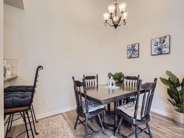 dining area with a notable chandelier and wood-type flooring