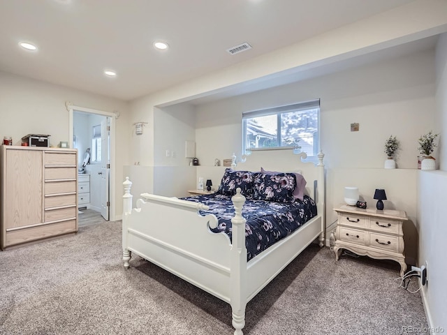 carpeted bedroom featuring ensuite bath