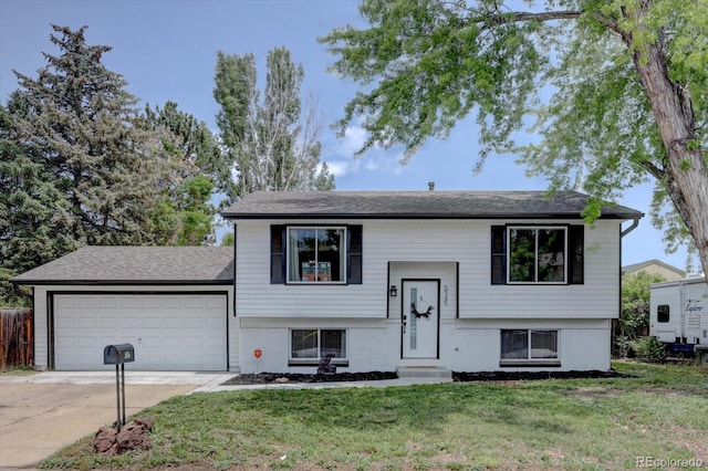 5945 W 86th Ave, Arvada, CO 80003 - split foyer home featuring a garage, driveway, a front lawn, and entry steps