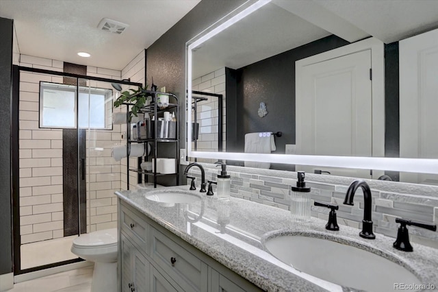 5945 W 86th Ave, Arvada, CO 80003 - bathroom featuring a shower stall, toilet, and double vanity