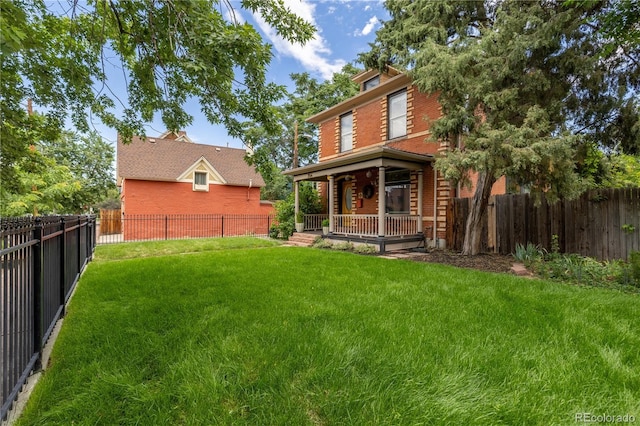 256 Bannock St, Denver, CO 80223 - back of property featuring brick siding, a fenced backyard, and covered porch