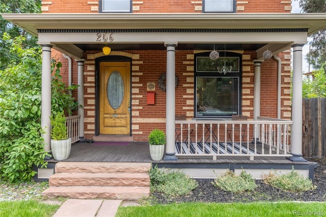 256 Bannock St, Denver, CO 80223 - property entrance featuring covered porch and brick siding