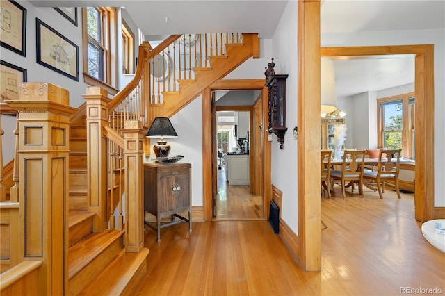 256 Bannock St, Denver, CO 80223 - staircase with wood finished floors and a chandelier