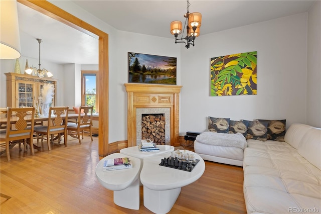 256 Bannock St, Denver, CO 80223 - living room with a chandelier, light wood-type flooring, and a fireplace