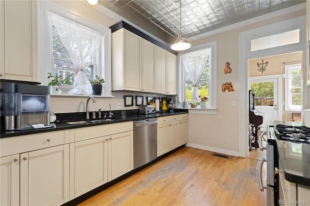 256 Bannock St, Denver, CO 80223 - kitchen with stainless steel appliances, an ornate ceiling, dark countertops, crown molding, and light wood-style flooring