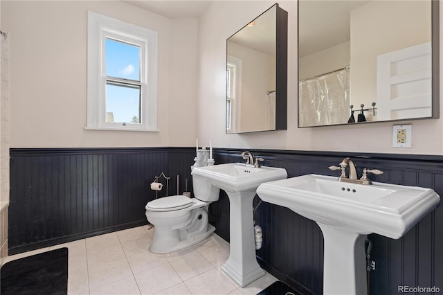 256 Bannock St, Denver, CO 80223 - bathroom with a wainscoted wall and tile patterned flooring