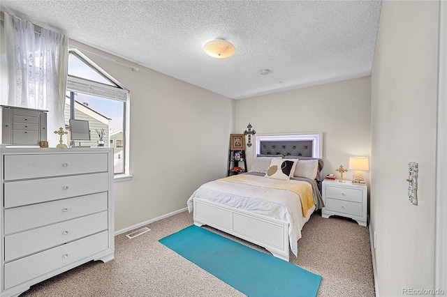 carpeted bedroom with a textured ceiling