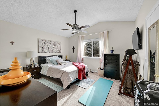 carpeted bedroom with ceiling fan, a textured ceiling, and vaulted ceiling