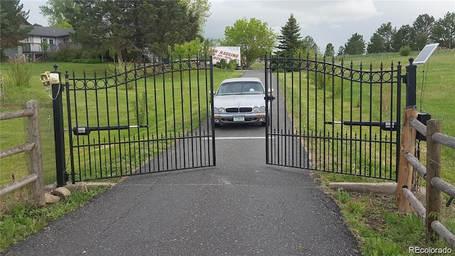 view of gate featuring a lawn