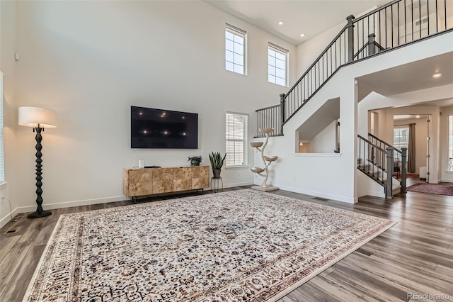 14551 Hudson St, Thornton, CO 80602 - living area with stairs, plenty of natural light, wood finished floors, a high ceiling, and recessed lighting