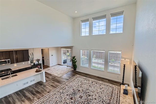 14551 Hudson St, Thornton, CO 80602 - home office featuring a high ceiling and dark wood-style floors