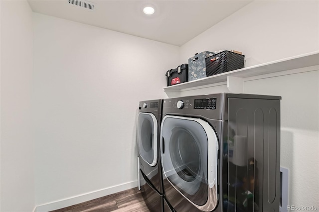 14551 Hudson St, Thornton, CO 80602 - washroom featuring separate washer and dryer and wood finished floors