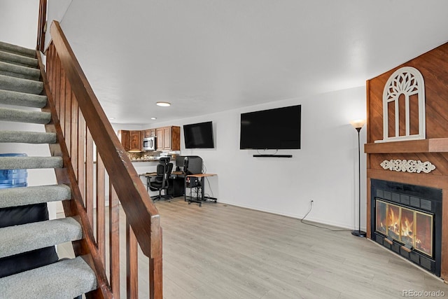 14396 E Temple Pl Unit D, Aurora, CO 80015 - stairs with wood finished floors, a glass covered fireplace, recessed lighting, and baseboards