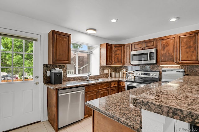 14396 E Temple Pl Unit D, Aurora, CO 80015 - kitchen featuring appliances with stainless steel finishes, a sink, healthy amount of natural light, tasteful backsplash, and recessed lighting
