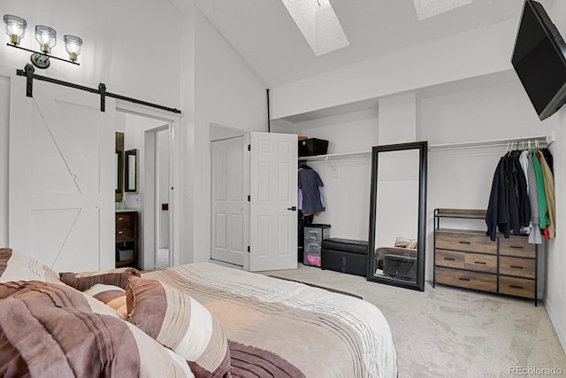 14396 E Temple Pl Unit D, Aurora, CO 80015 - carpeted bedroom featuring high vaulted ceiling, a skylight, a barn door, and ensuite bathroom