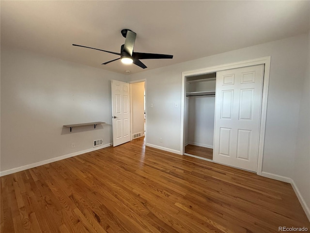 4670 Independence St, Wheat Ridge, CO 80033 - unfurnished bedroom with baseboards, wood finished floors, a closet, and a ceiling fan