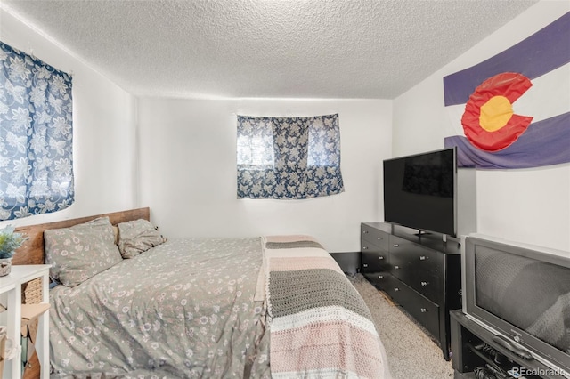 carpeted bedroom with a textured ceiling