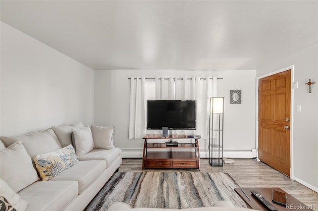 living room with hardwood / wood-style flooring and a baseboard heating unit