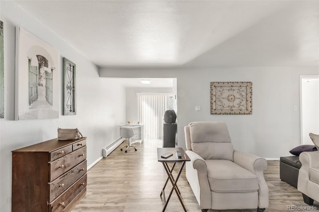 sitting room featuring light wood-type flooring and baseboard heating