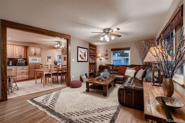 5900 W 62nd Ave, Arvada, CO 80003 - living room with a ceiling fan and light wood-style flooring