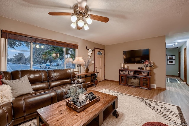 5900 W 62nd Ave, Arvada, CO 80003 - living area with wood finished floors, a ceiling fan, and a textured ceiling