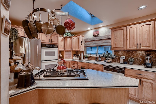 5900 W 62nd Ave, Arvada, CO 80003 - kitchen featuring stainless steel appliances, a skylight, light countertops, and recessed lighting