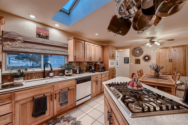5900 W 62nd Ave, Arvada, CO 80003 - kitchen featuring white appliances, a skylight, a ceiling fan, backsplash, and light countertops