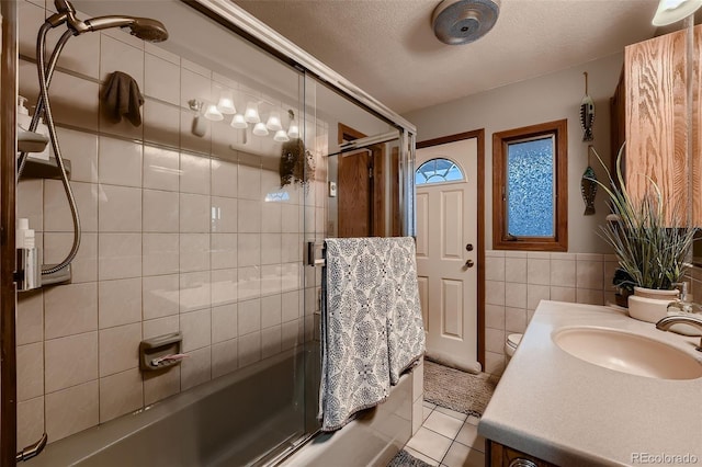 5900 W 62nd Ave, Arvada, CO 80003 - full bath with vanity, enclosed tub / shower combo, tile walls, tile patterned floors, and wainscoting