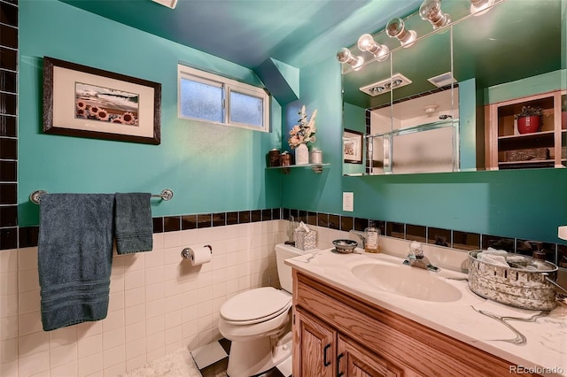 5900 W 62nd Ave, Arvada, CO 80003 - full bathroom featuring a shower stall, vanity, a wainscoted wall, and tile walls