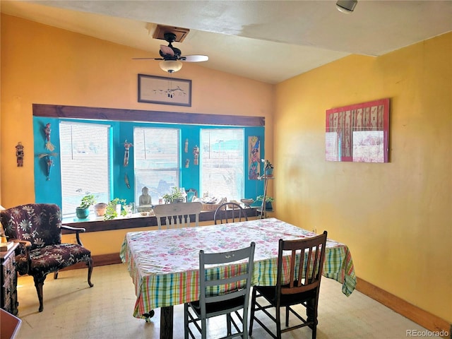 dining area with ceiling fan, carpet flooring, and vaulted ceiling