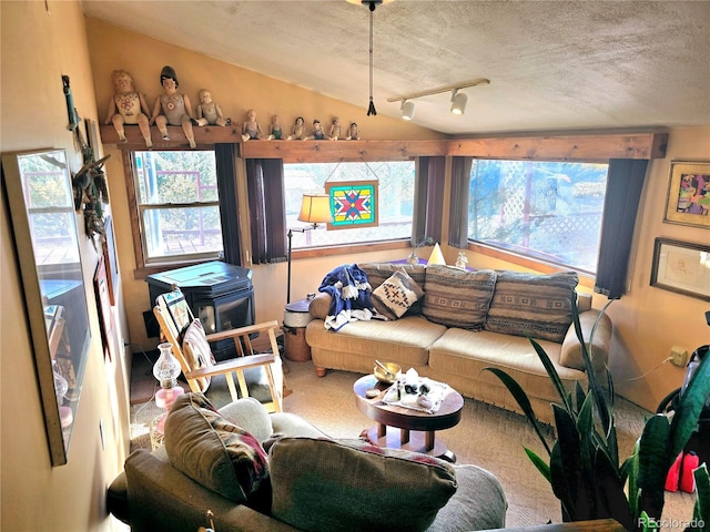 carpeted living room with a textured ceiling, vaulted ceiling, and track lighting