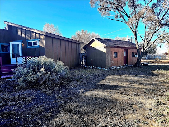 view of property exterior with a storage shed