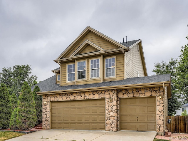 5553 Jasper St, Denver, CO 80239 - view of front facade with stone siding, concrete driveway, and a shingled roof