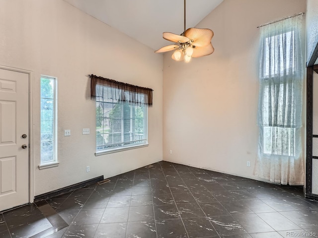 5553 Jasper St, Denver, CO 80239 - foyer entrance with high vaulted ceiling, ceiling fan, and tile patterned floors