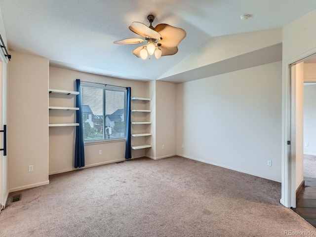5553 Jasper St, Denver, CO 80239 - unfurnished bedroom featuring carpet, vaulted ceiling, and ceiling fan