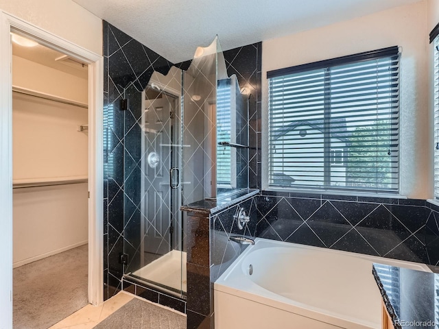 5553 Jasper St, Denver, CO 80239 - bathroom with a garden tub, a shower stall, and a walk in closet