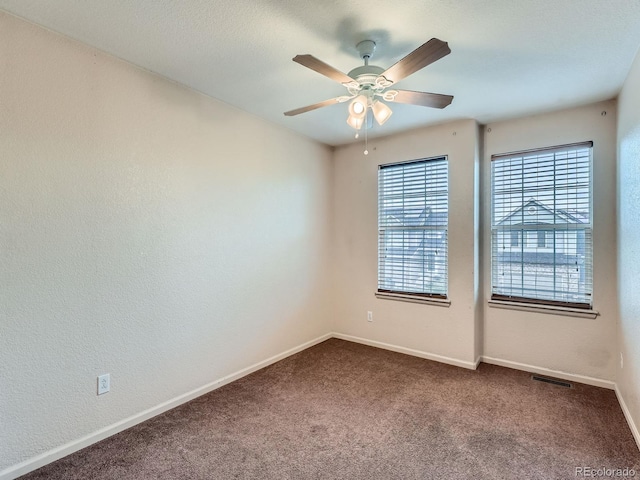 5553 Jasper St, Denver, CO 80239 - empty room featuring ceiling fan and dark carpet