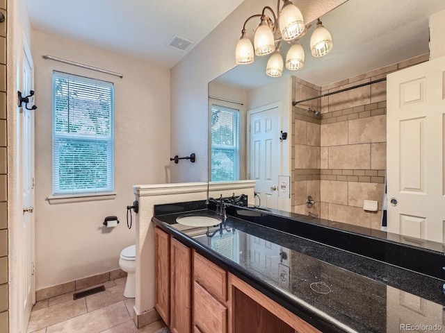 5553 Jasper St, Denver, CO 80239 - full bathroom featuring double vanity, tiled shower, tile patterned flooring, and plenty of natural light