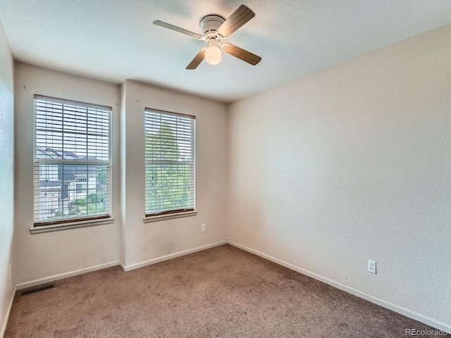 5553 Jasper St, Denver, CO 80239 - carpeted spare room with a ceiling fan, a textured wall, and a textured ceiling