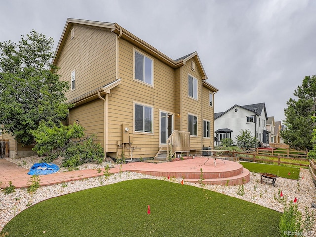 5553 Jasper St, Denver, CO 80239 - rear view of property featuring a patio area and an outdoor fire pit