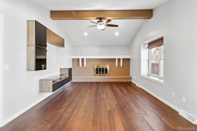 unfurnished living room featuring dark hardwood / wood-style floors, lofted ceiling with beams, and a fireplace