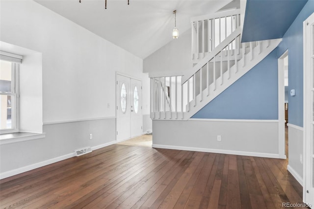 unfurnished living room featuring wood-type flooring and high vaulted ceiling