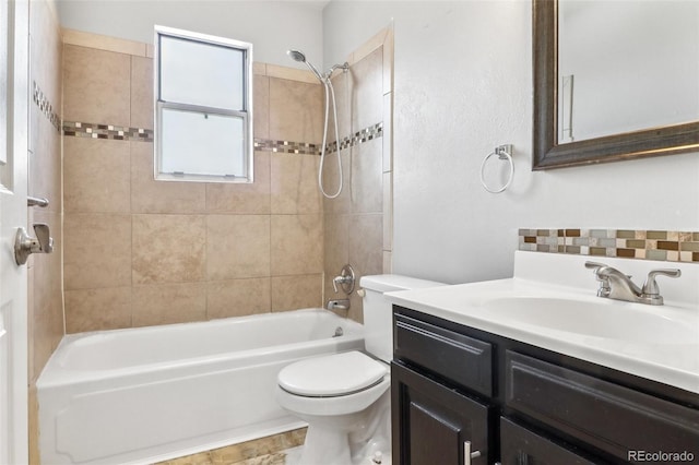 full bathroom with vanity, toilet, and tiled shower / bath combo