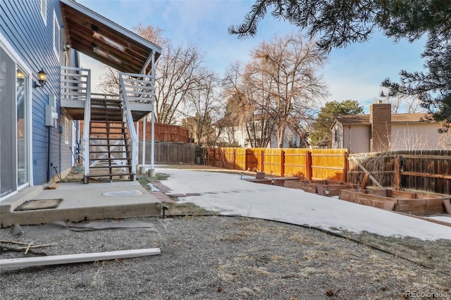 view of yard featuring a patio area and a wooden deck