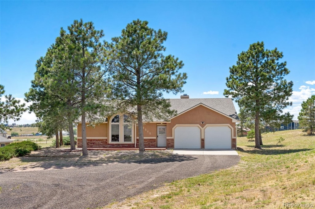 view of front of property with a front yard, a garage, and a porch