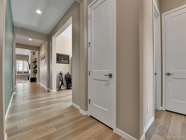 11464 Stonewash St, Littleton, CO 80125 - hallway featuring light wood-type flooring, baseboards, recessed lighting, and a textured wall
