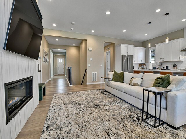 11464 Stonewash St, Littleton, CO 80125 - living room featuring light wood-style floors, recessed lighting, and baseboards