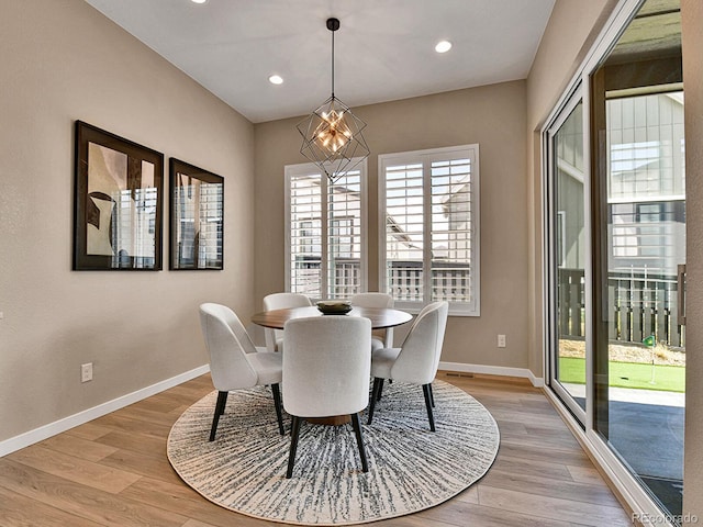 11464 Stonewash St, Littleton, CO 80125 - dining room featuring baseboards, light wood-style flooring, recessed lighting, and a chandelier