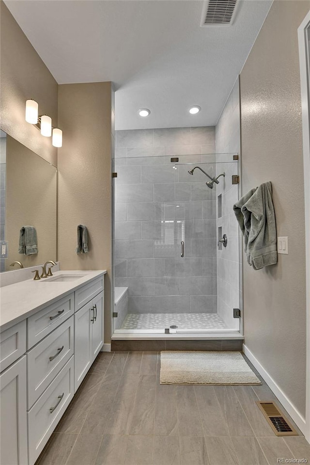 11464 Stonewash St, Littleton, CO 80125 - bathroom featuring a stall shower, vanity, baseboards, and recessed lighting